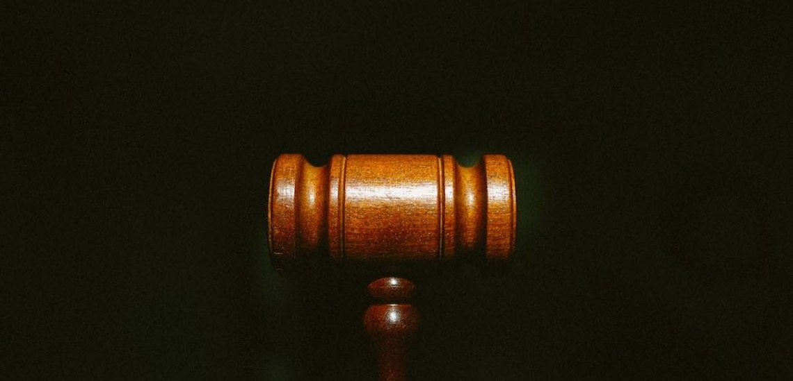 wooden gavel against black background symbolizing 2022 web accessibility lawsuits