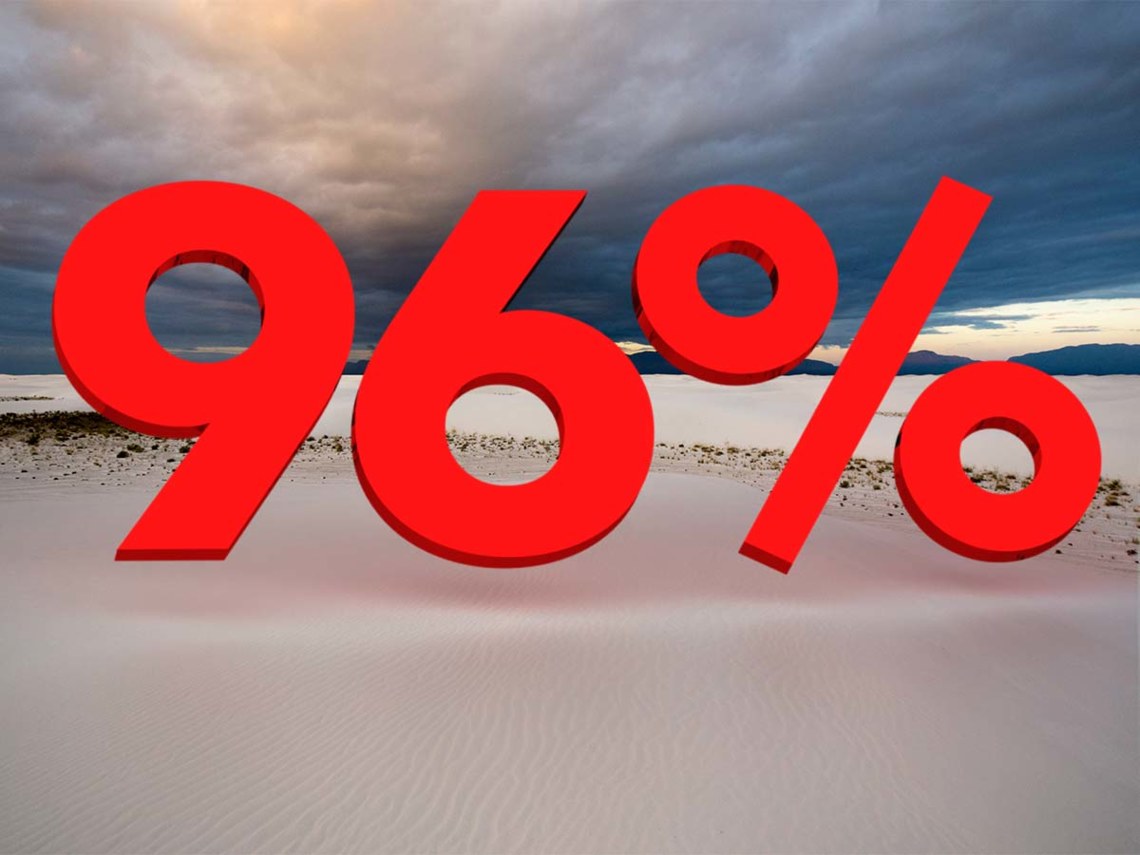 96% sign in desert with mountains in distance
