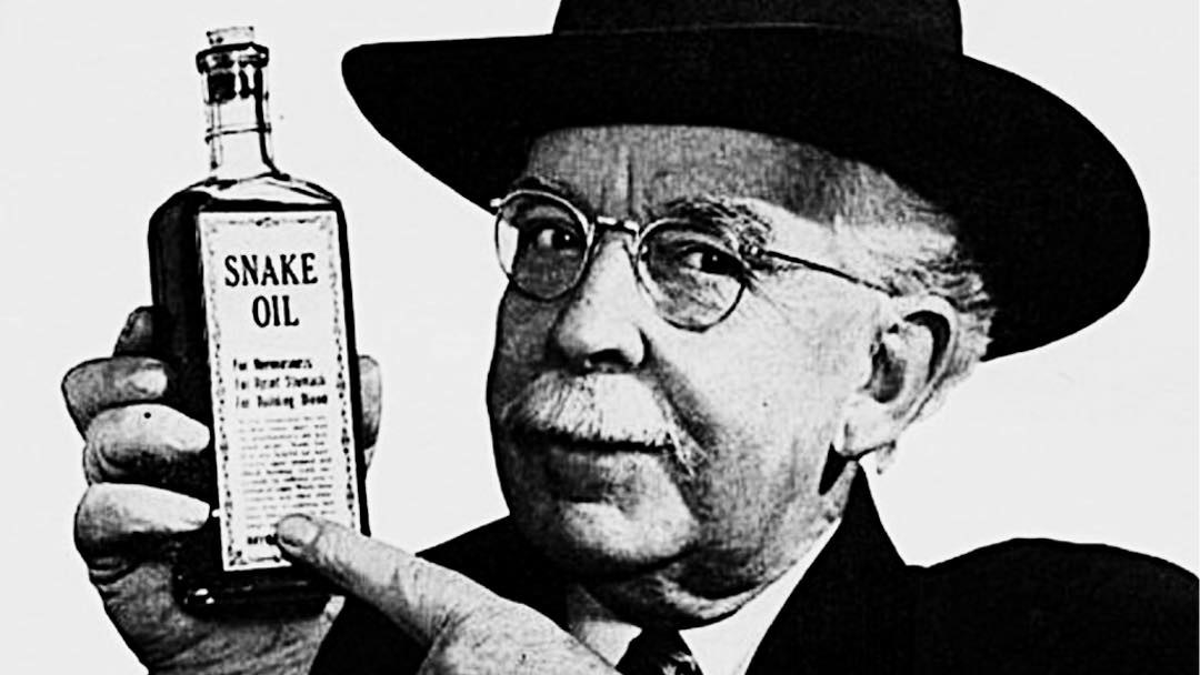 man with hat holding a medicine bottle of snake oil