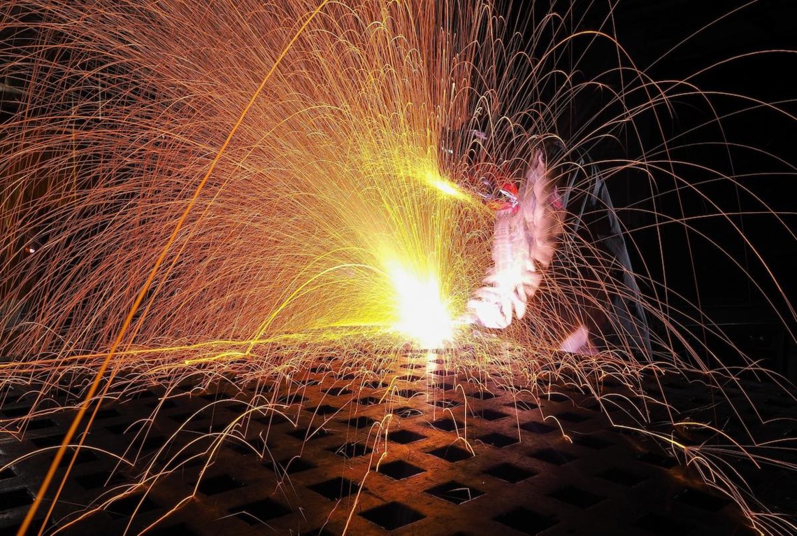 welder welding with sparks flying as parallel to WCAG website remediation for ADA compliance